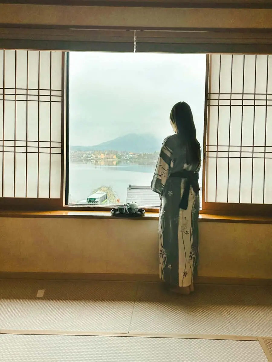 (2026) Postcard From a Ryokan A ryokan room with shoji screens looking onto water, Japan