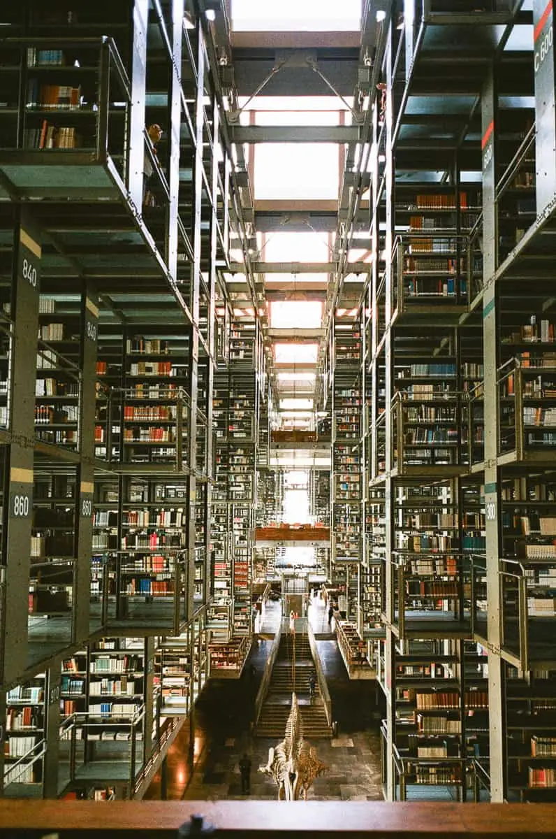 (2026) Postcards From: Biblioteca Vasconcelos CDMX Central nave of Biblioteca Vasconcelos, daylight falling down seven stories of suspended bookshelves